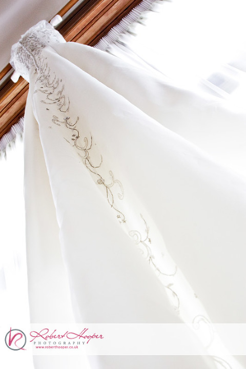 Kamila's wedding dress hanging over the window 1009-KFPH-0007