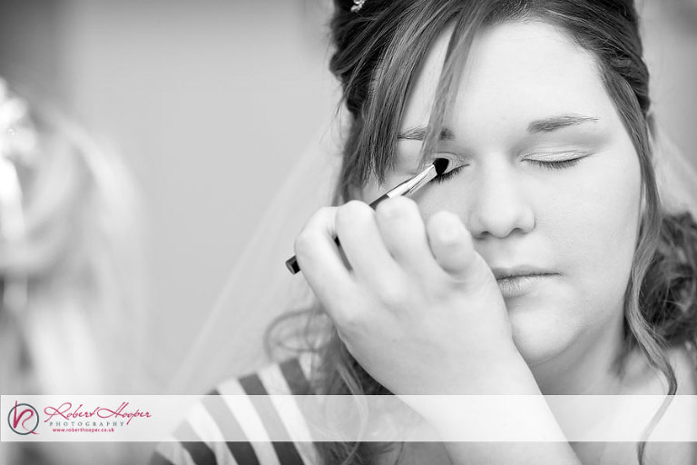 Bride's makeup being applied 