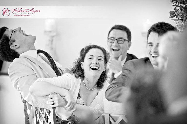 Wedding guests laughing at speeches 