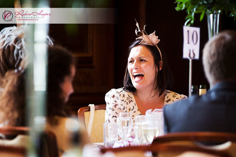 Wedding guests laughing at speeches at Addington Palace 