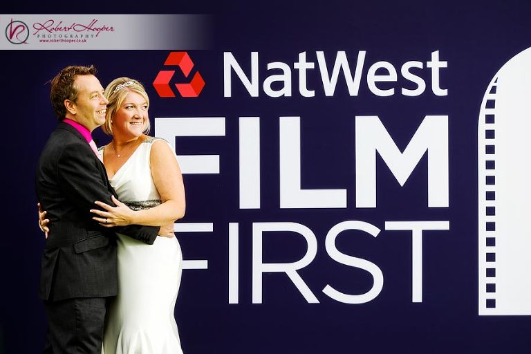 Bride and Groom posing in front of Natwest sign 