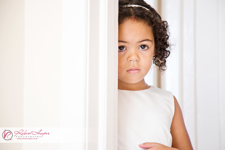Shy flower girl on wedding day 