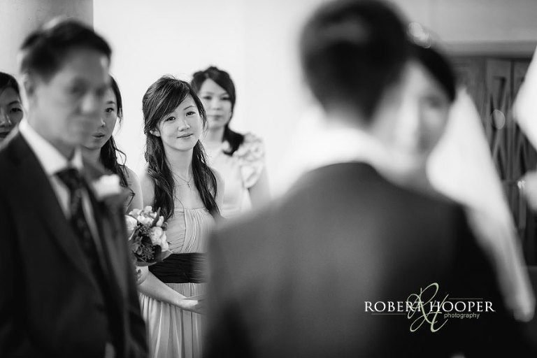 Bridesmaid watching wedding church ceremony