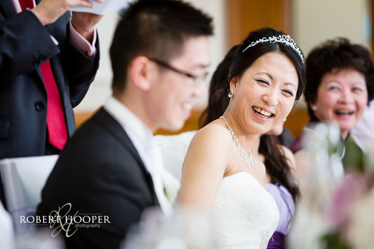 Laughing Chinese bride at Kent wedding reception