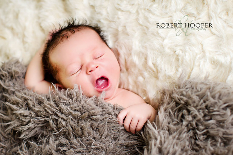 Sleepy neborn baby yawning