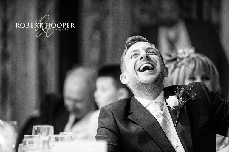 groom laughing at dorking wedding reception