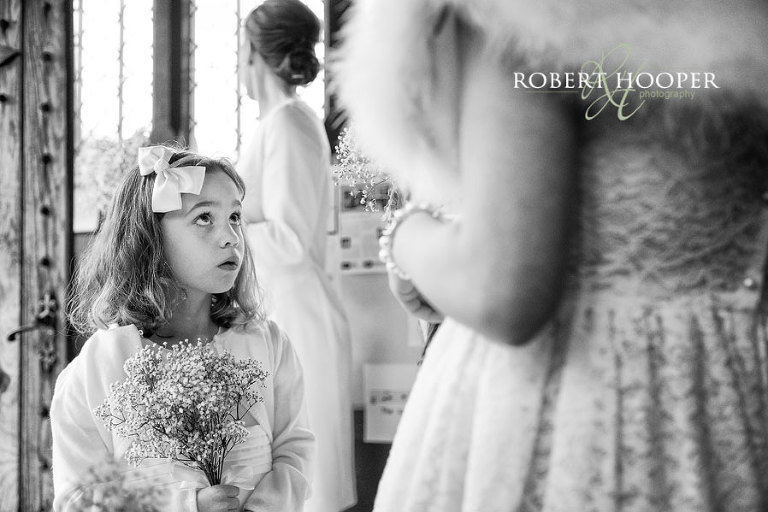 Flower girl at Kent wedding ceremony in church doorway