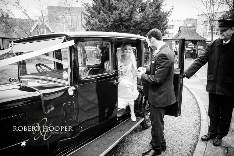 Bride arrives at church in vintage car at Kent wedding ceremony