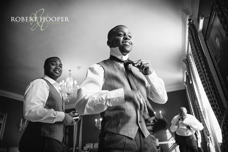 Groomsmen having fun preparing for Addington Palace wedding