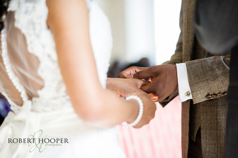 Addington Palace wedding photography - exchange of wedding rings during wedding ceremony
