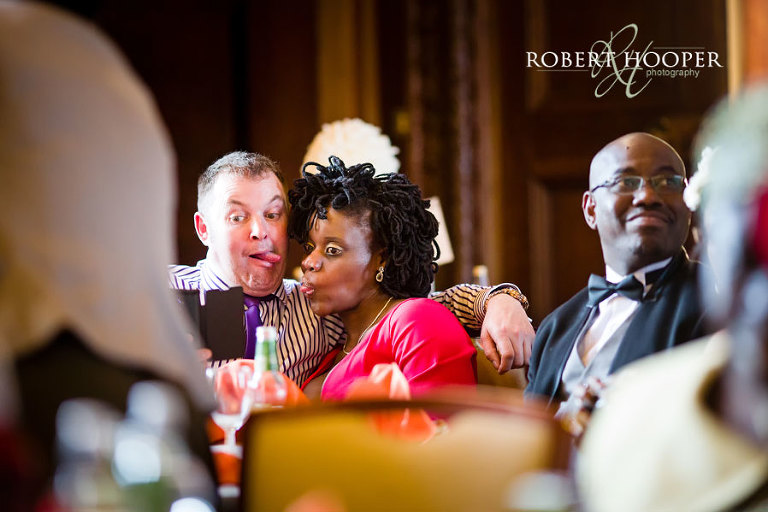 Addington Palace wedding reception - guests having fun in the great hall before wedding speeches
