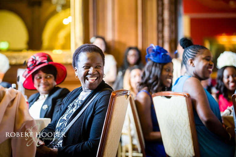 Addington Palace wedding reception - guests laughing at wedding speeches from best man and groom after wedding breakfast in the great hall