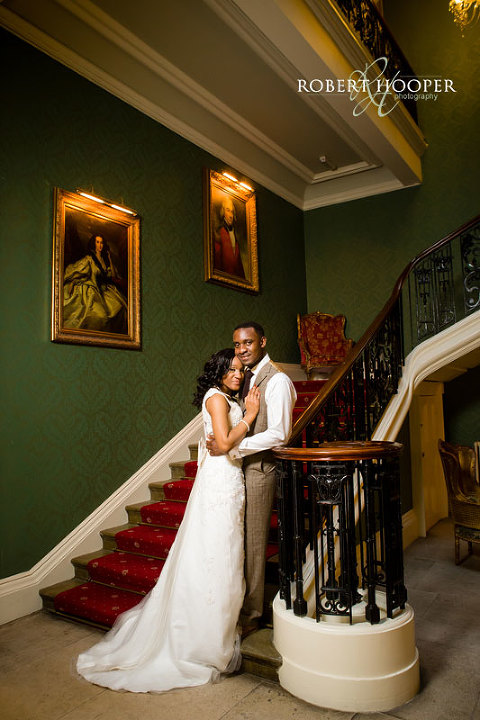Addington Palace wedding photography in Surrey - bride and groom on staircase