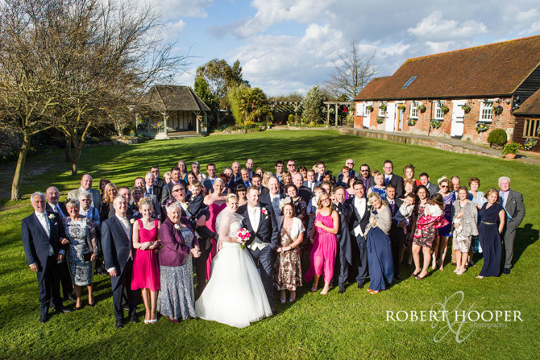 Wedding party big group photo at Cooling Castle Barn in Rochester, Kent