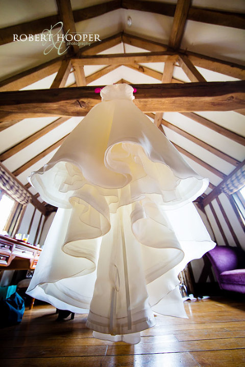 Wedding dress hanging at Cain Manor wedding in Surrey