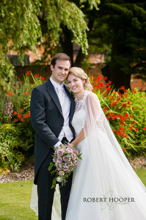 Beautiful wedding picture of bride and groom in gardens at Cain Manor Surrey