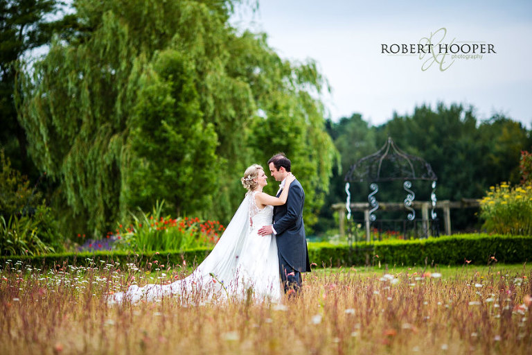 Bride and groom picture in the wild flowers at Cain Manor wedding venue in Surrey