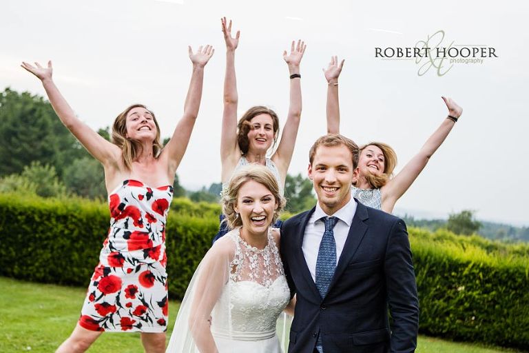 Wedding guests photo bombing picture of the bride at Bijou wedding in Surrey