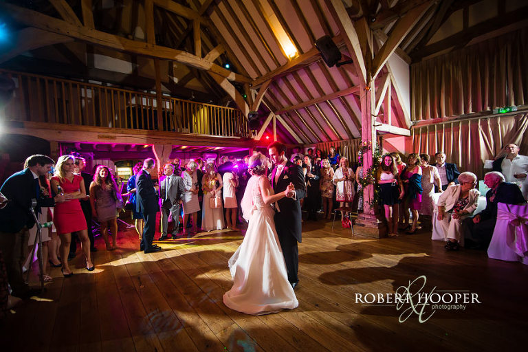 Colourful picture of bride and groom's first dance at Cain Manor Barn wedding venue in Surrey