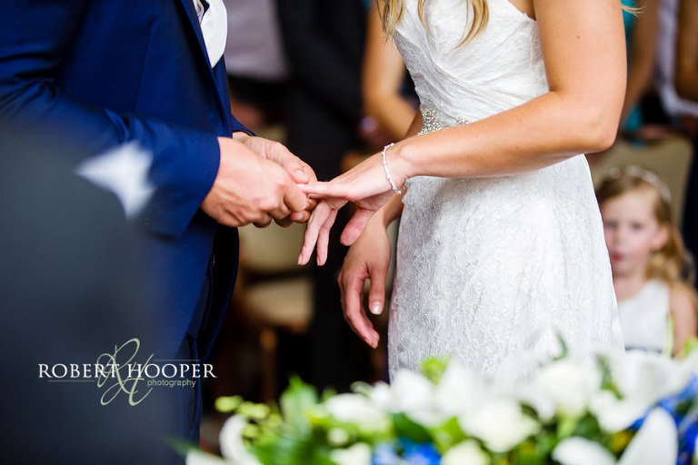The exchange of rings at marriage ceremony in the Winter Garden Room at Addington Palace, Croydon in Surrey