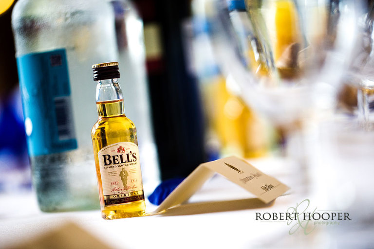 Miniature Bell's blended Scotch Whiskey as table decoration and gift for wedding guests at wedding breakfast at Addington Palace, Croydon, Surrey