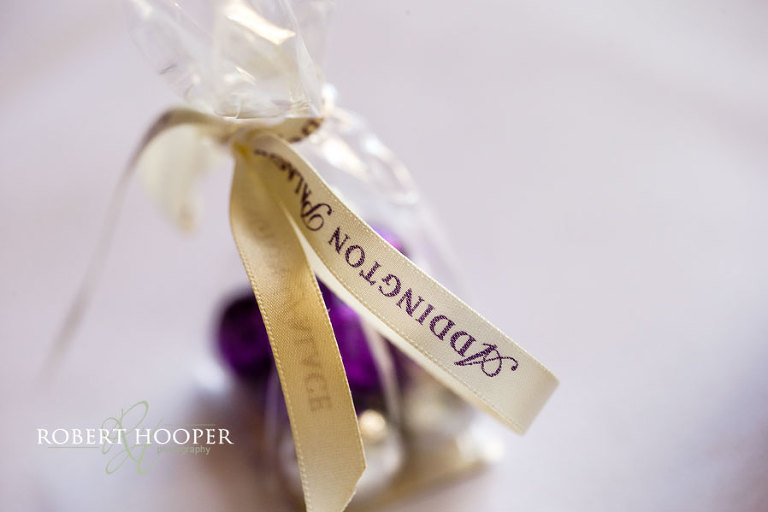 Favours with purple theme on tables for wedding breakfast at Addington Palace Surrey