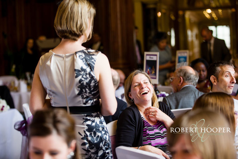 Wedding guests enjoying the wedding breakfast in the Great Hall at Addington Palace in Surrey