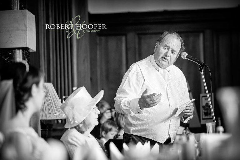 Father of the bride giving his speech during wedding breakfast in The Great Hall at Addington Palace, Surrey