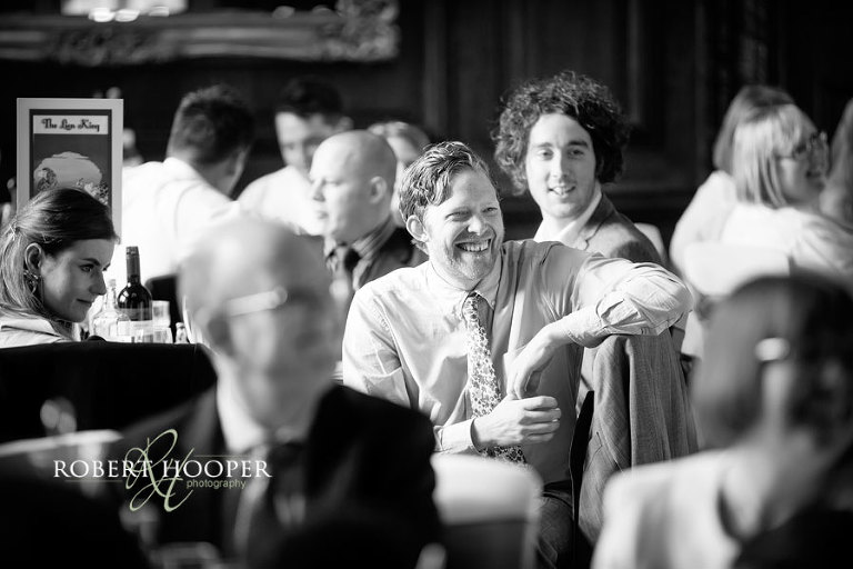 Wedding guests during wedding breakfast speeches in the Great Hall, Addington Palace in Surrey