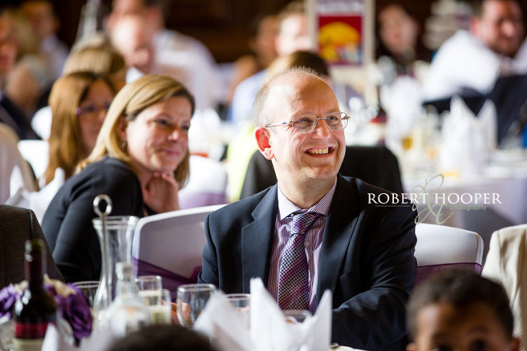 Wedding guests enjoying the wedding breakfast and speeches in the Great Hall at Addington Palace in Croydon, Surrey