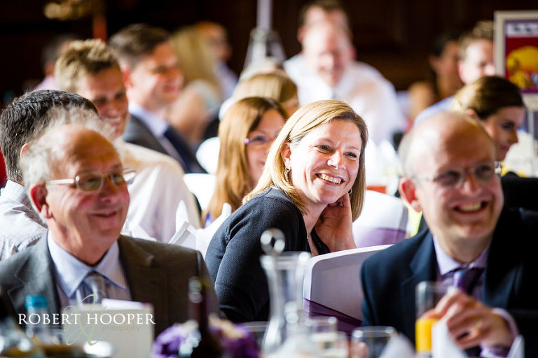Wedding guests enjoying the wedding breakfast and speeches in the Great Hall at Addington Palace in Croydon, Surrey