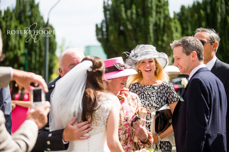 Guests congratulating bride and groom after their wedding at St. Mary's Church in Wimbledon, London