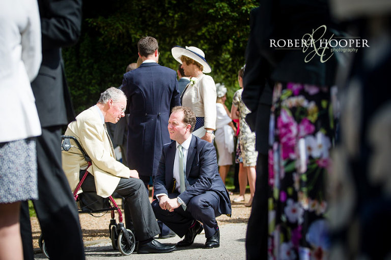 Wedding guests socialising outside church on wedding day in Wimbledon in London