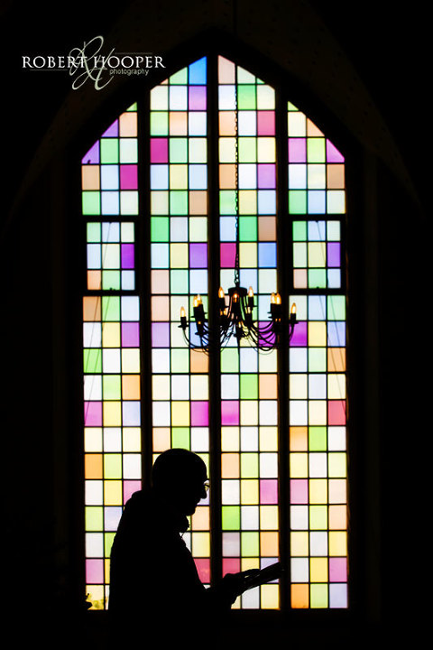 Artistic silhouette of vicar during wedding service at All Saints Church, Orpington, Kent