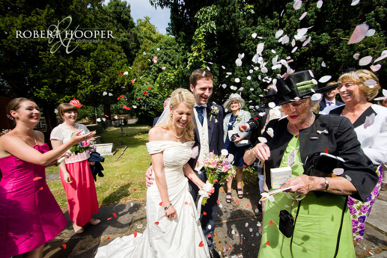 Surrey bride and bride groom confetti shot at Church wedding at All Saints Church, Orpington, Kent