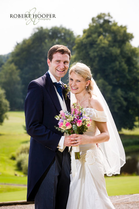 Kent bride and bride groom posing for a traditional wedding shot at Westerham Golf Club