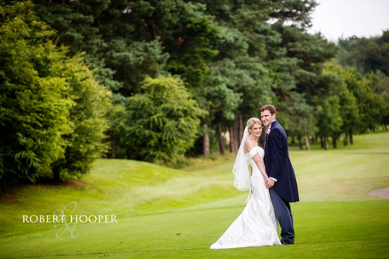 Stunning bride and her bride groom on golf course at Westerham wedding venue in Kent
