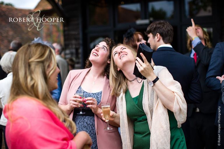 Guests at wedding reception watching Red Arrows overhead at Bix Manor, Henley-on-Thames in Oxfordshire