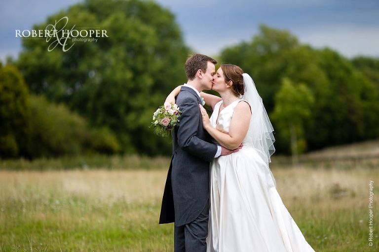 Bride and groom kiss after on their wedding day at Bix Manor in Oxfordshire