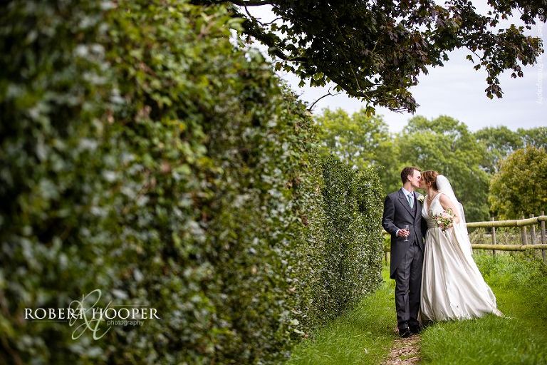 Bride and groom walk together after wedding ceremony at Bix Manor, Henley-on-Thames, Oxfordshire