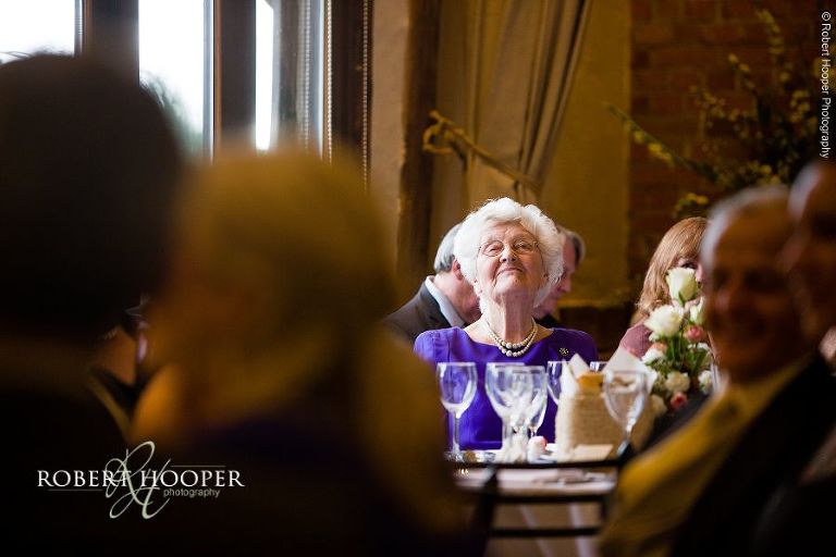 Wedding guest at wedding breakfast held in Great Tithe Barn, Bix Manor, Henley-on-Thames in Oxfordshire