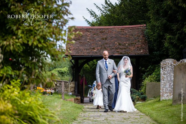 Bride arriving with bridal party at church in Send, Surrey on her wedding day
