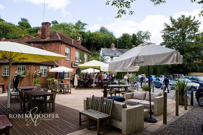 Wedding party enjoying reception at The Stag on the River, Eashing in Surrey