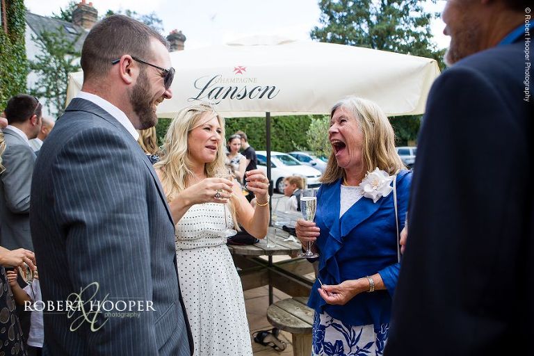 Wedding guests enjoying reception at The Stag on the River in Eashing, Surrey