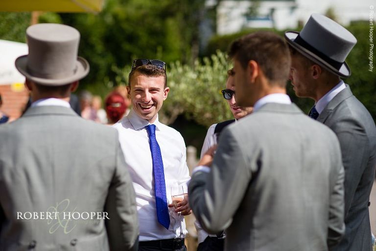 Wedding guests enjoying pub reception on beautiful summer day in Eashing, Surrey