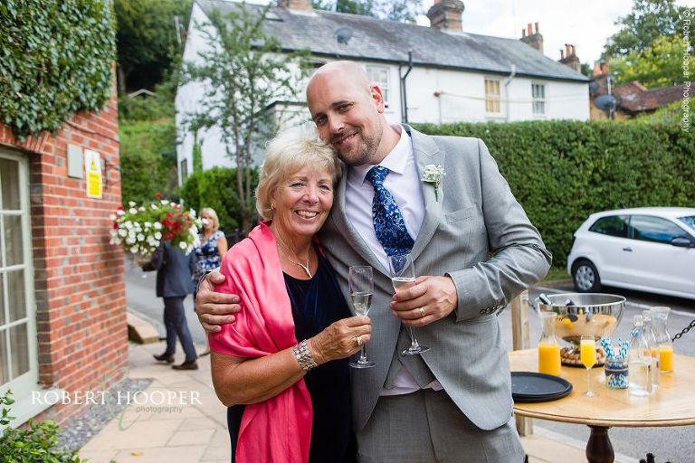 Wedding guests at summer wedding reception at The Stag on the River, Eashing in Surrey