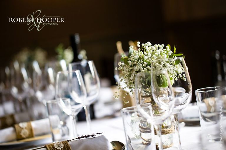 Wedding breakfast table set ready for guests, with gyp flowers as centre piece at Stag on the River, Eashing in Surrey