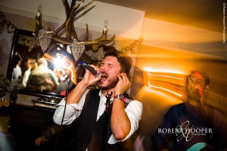 Singer with live band at evening wedding reception at The Stag on the River, Eashing in Surrey