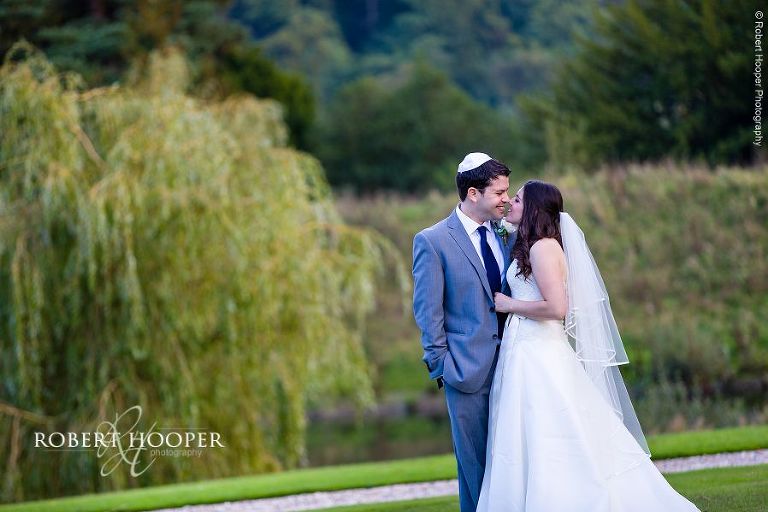 Bride and groom sharing a moment in the grounds of Northbrook Park wedding venue after their marriage