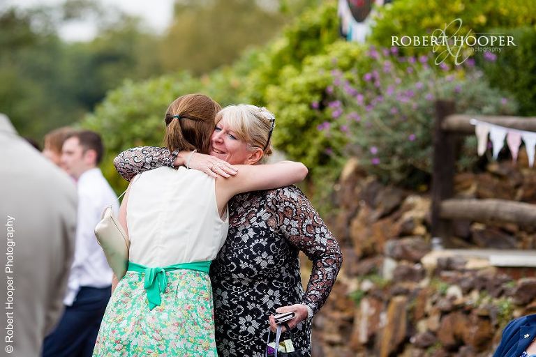 Wedding guests greeting each other at Coltsford Mill, Oxted in Surrey